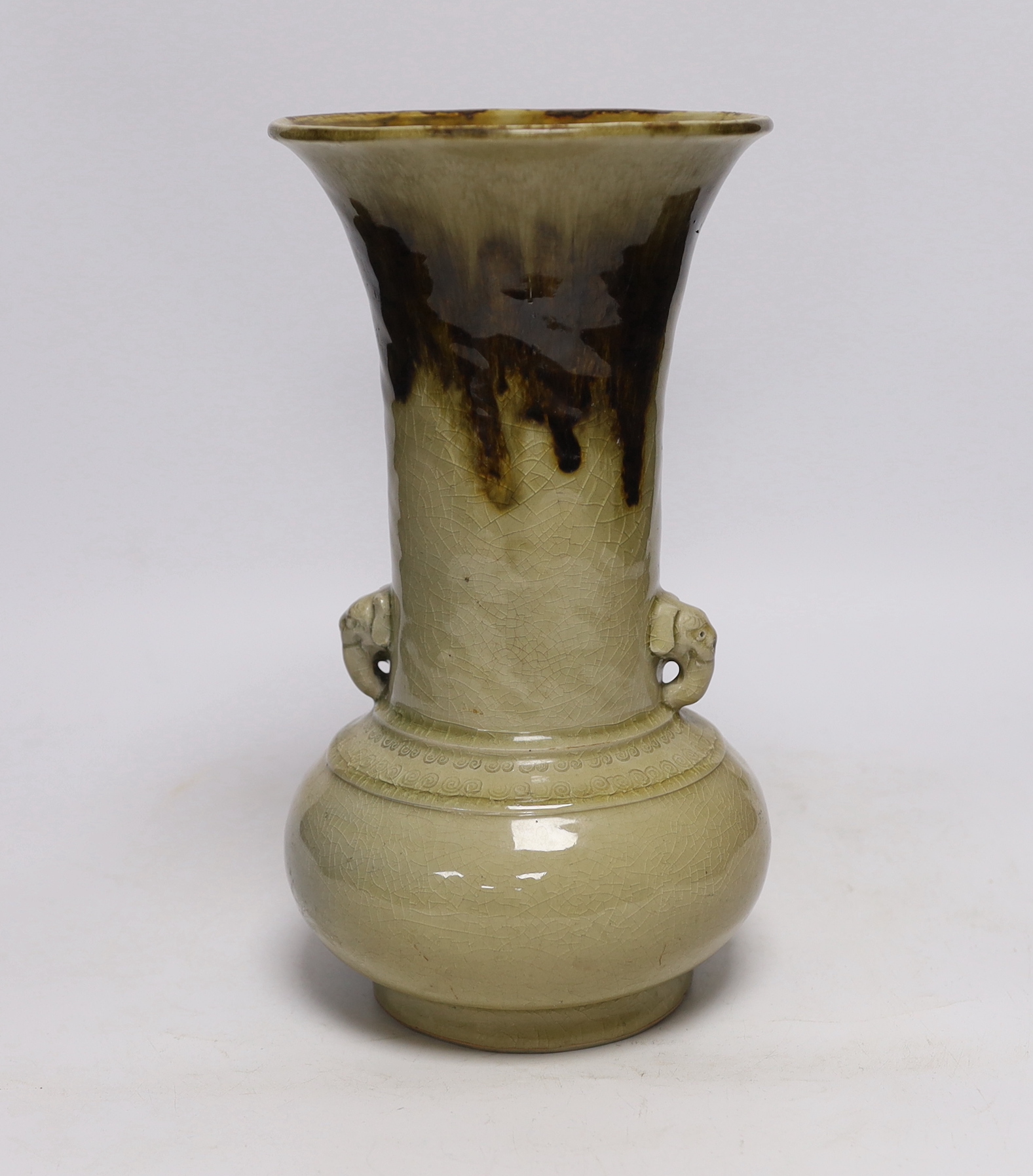 A Japanese celadon and brown glazed vase with mythical beast handles, 27cm